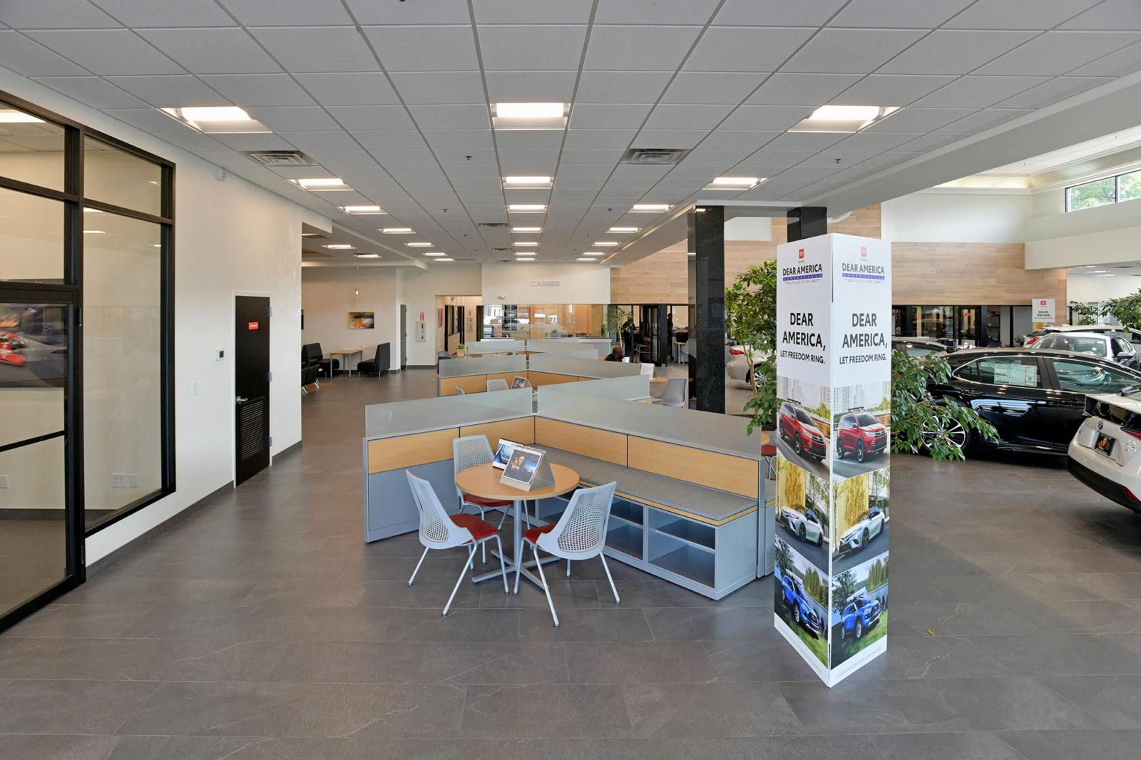 Overall view of the main showroom at a car dealership, showing Herman Miller Canvas workstations and seating as the sales area.