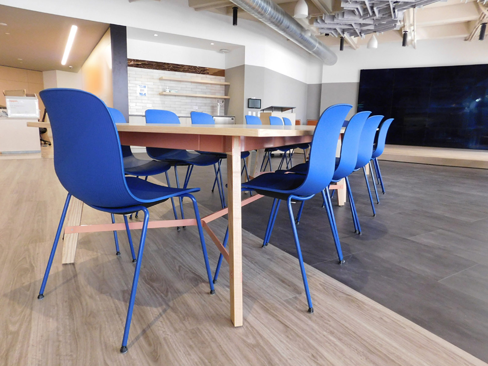 Blue poly chairs with blue metal legs, light wooden table
