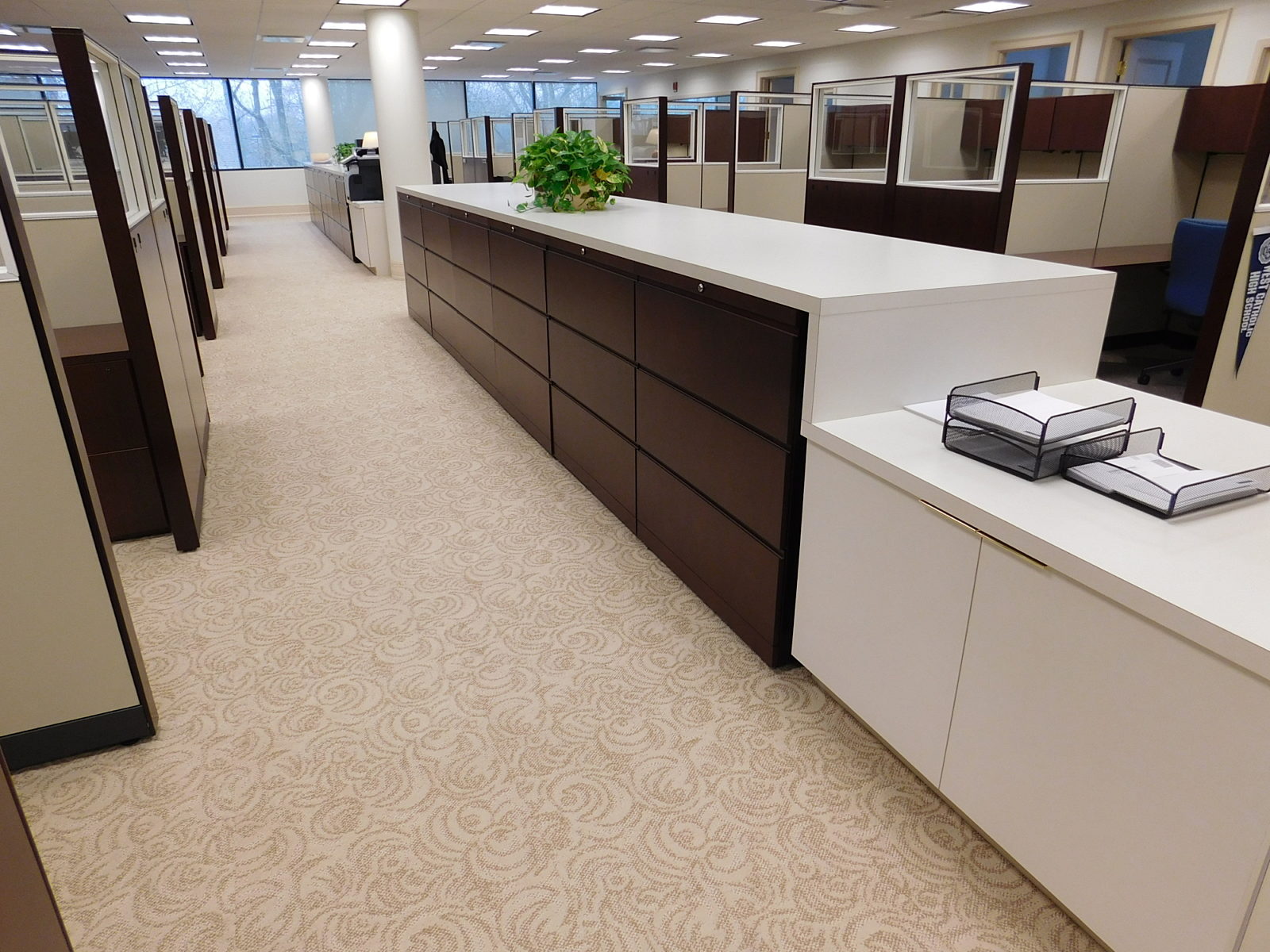 File bank with dark wood veneer drawer fronts, white laminate surround and surface
