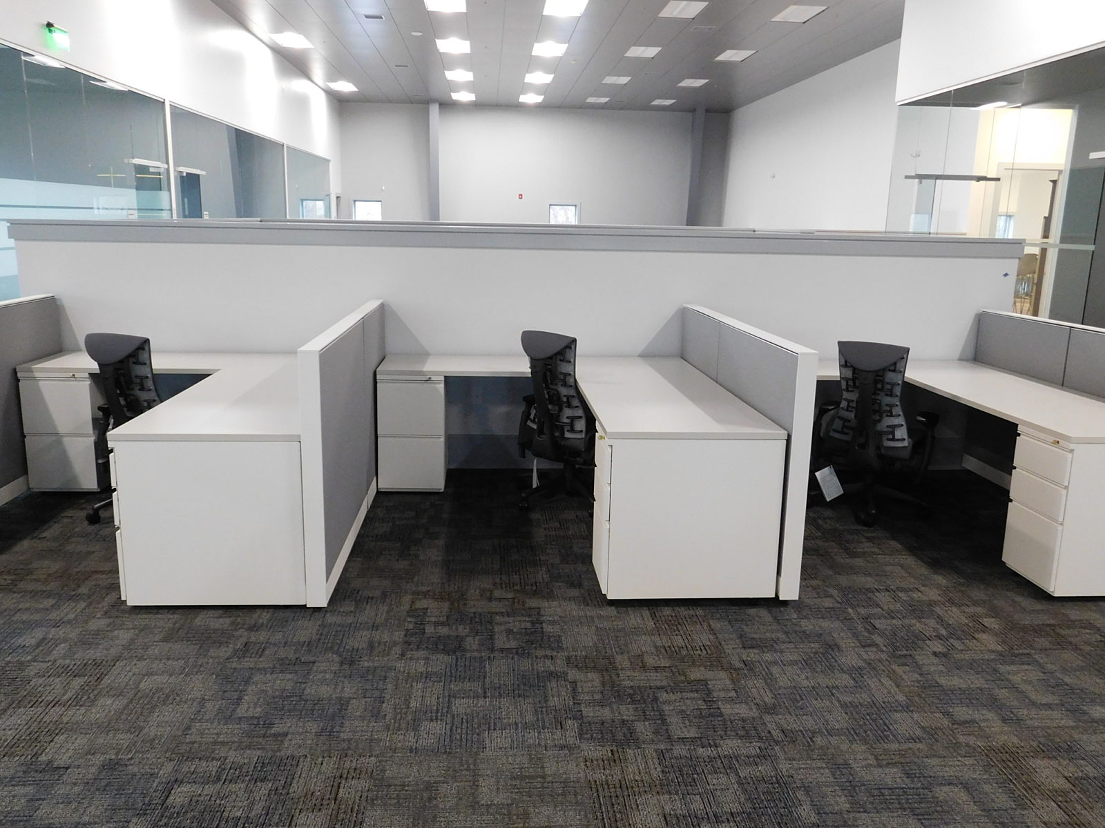 Herman Miller L-shape workstations with white storage and surfaces, grey fabric panels, Embody chairs