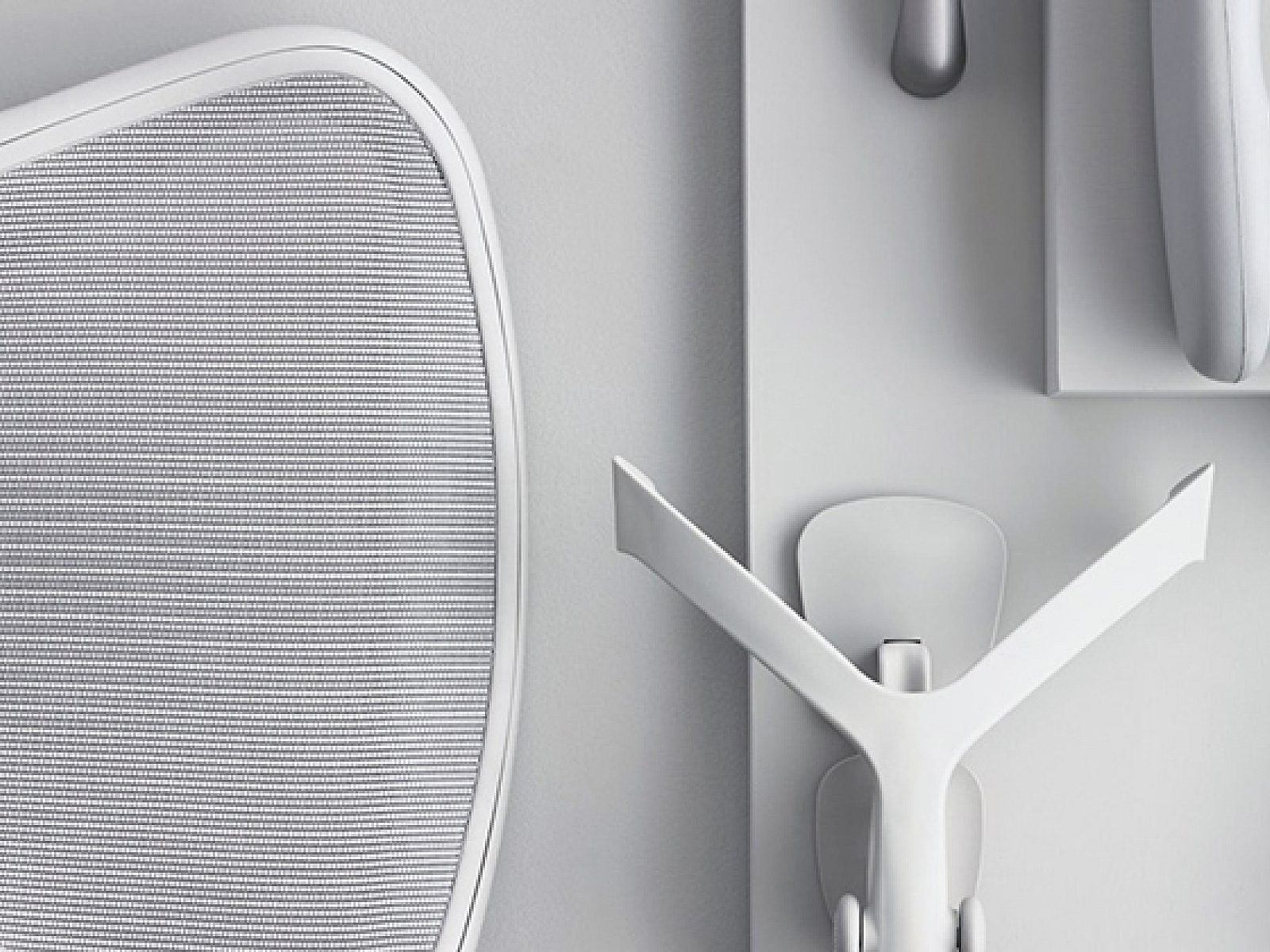 A light grey image with different parts and pieces of a Herman Miller Aeron Chair in mineral finish.