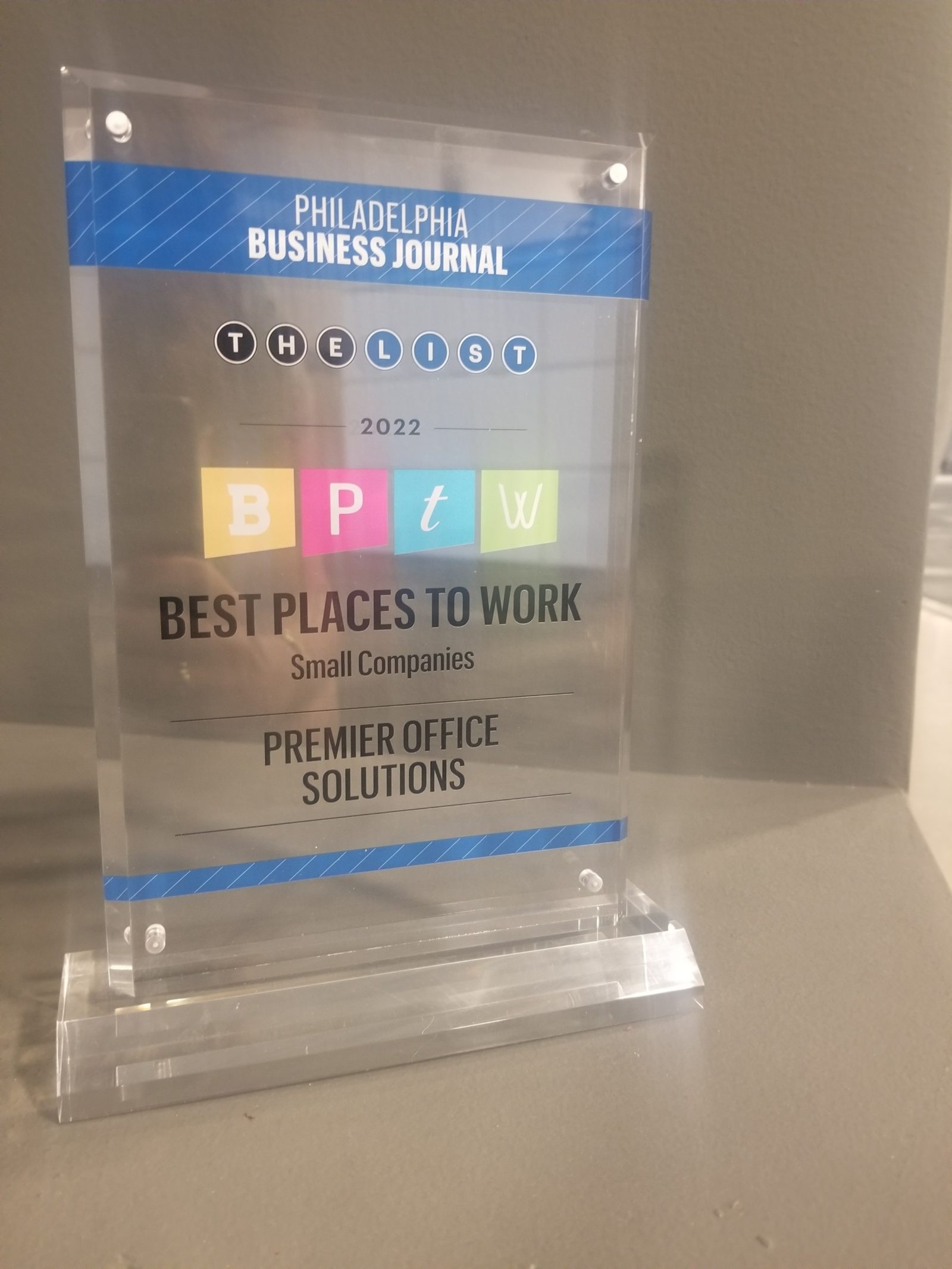 Acrylic desktop award with the Best Places to Work logo and Premier Office Solutions listed as a winner.