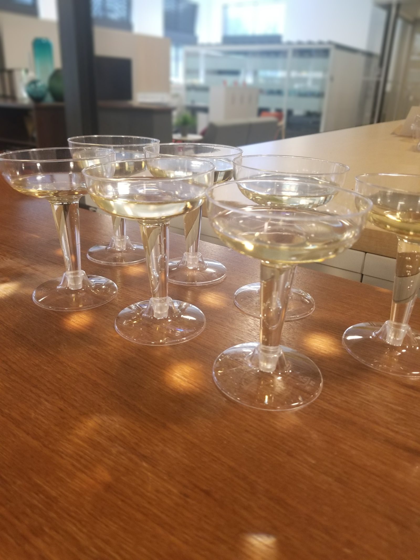 A group of champagne glasses filled with champagne (for our toast to celebrate Best Places to Work).