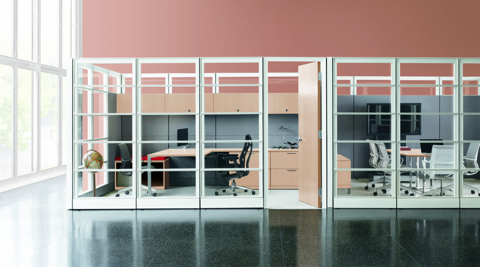 Offices enclosed by Herman Miller Ethospace glass walls. Private office is a light wood-grain laminate finish and has black Embody task chair.