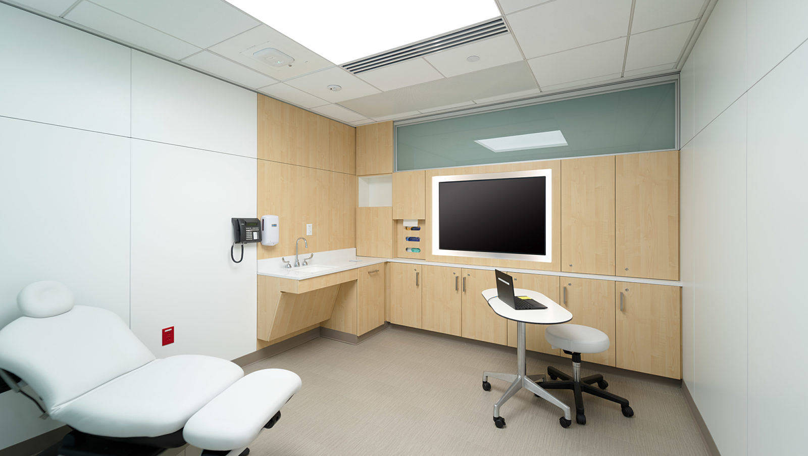 Medical exam room with DIRTT wall systems, integrated panels and technology